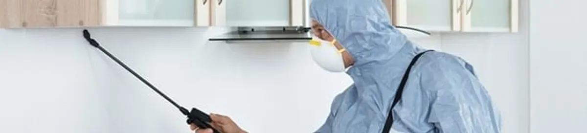 Termite treatment technician applying indoor pest control spray in Anaheim, CA