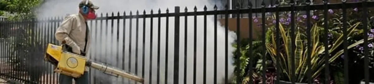 Mosquito control technician fogging a yard perimeter for mosquito reduction in Anaheim, CA